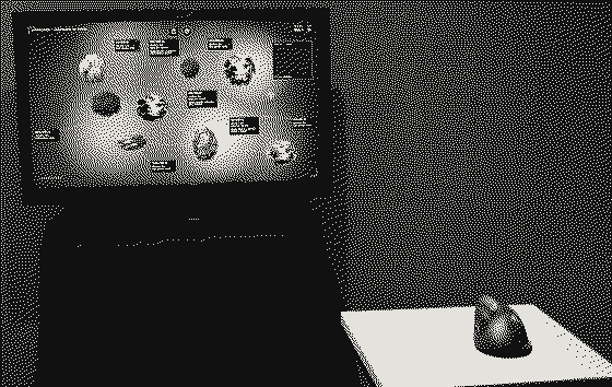 El dispositivo: un televisor sobre una base negra muestra especímenes esféricos sobre fondo azul; adelante, un mouse vertical sobre un pedestal blanco